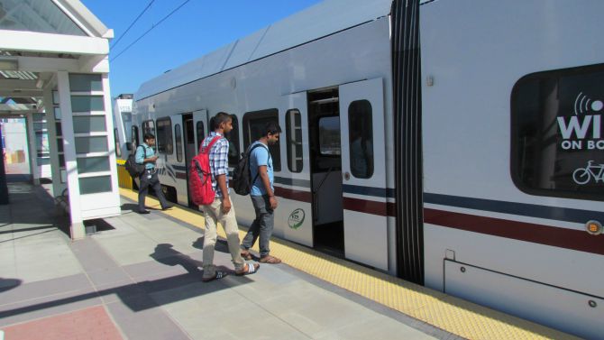 passengers board vta train